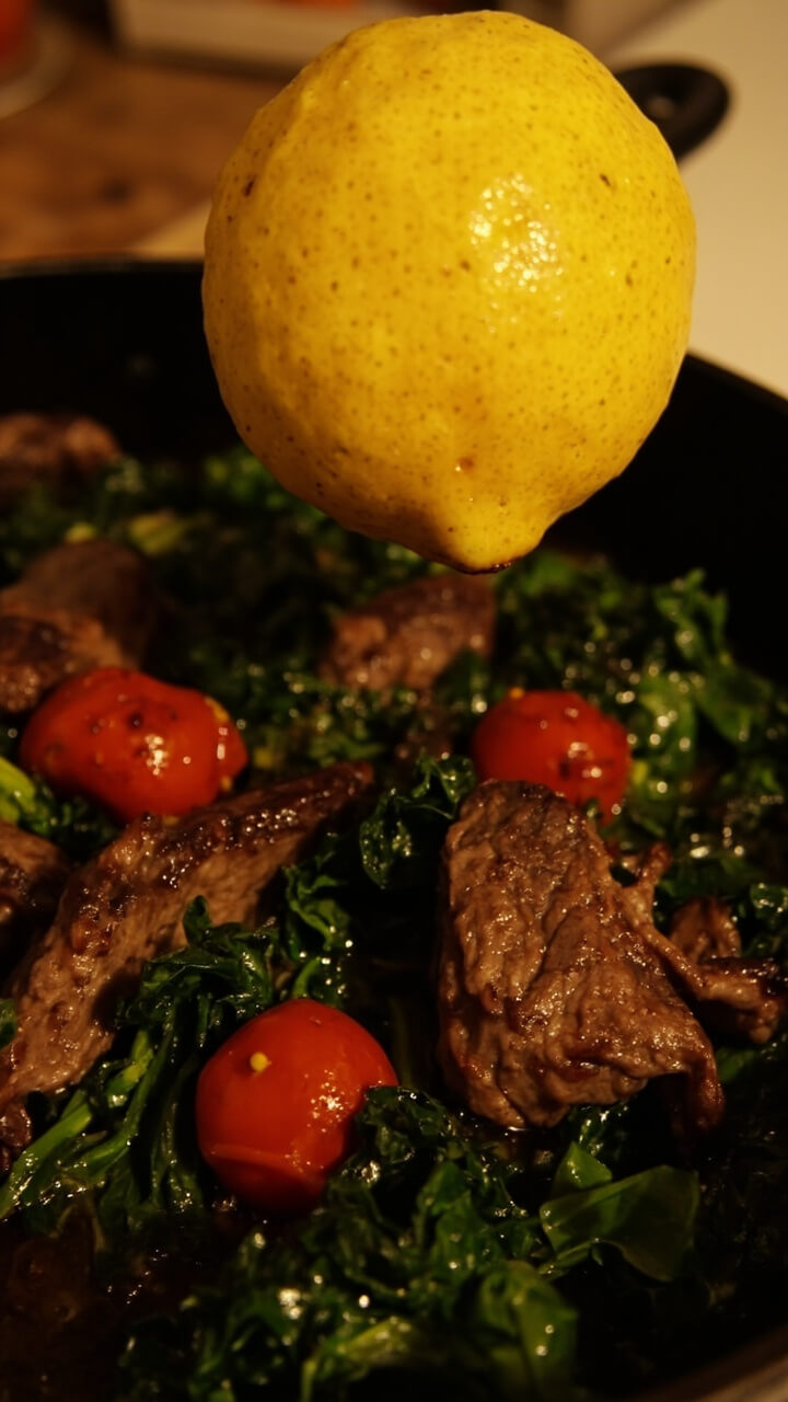 Tender steak strips mixed with wilted kale and roasted cherry tomatoes in a cast iron skillet, finished with a squeeze of lemon. Tender steak strips mixed with wilted kale and roasted cherry tomatoes in a cast iron skillet, finished with a squeeze of lemon.